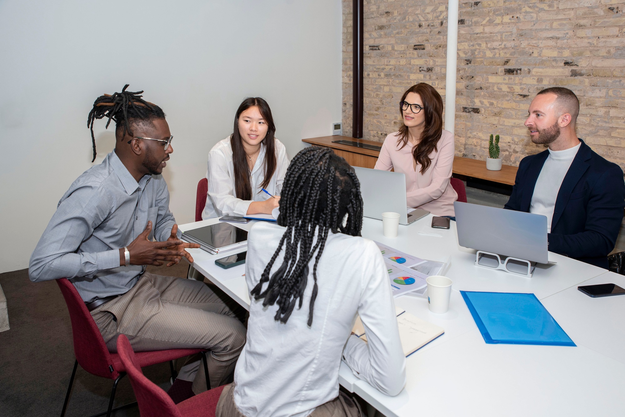 team of professionals multi ethnic business people negotiating in boardroom