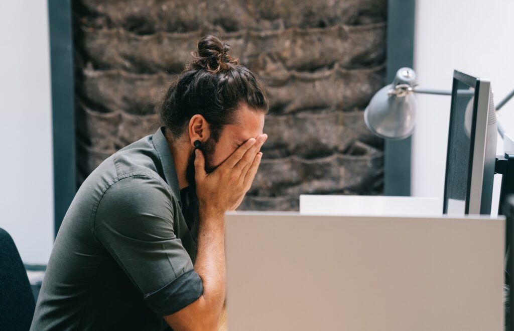 Tired depressed bored businessman frustrated by business failure bankruptcy.